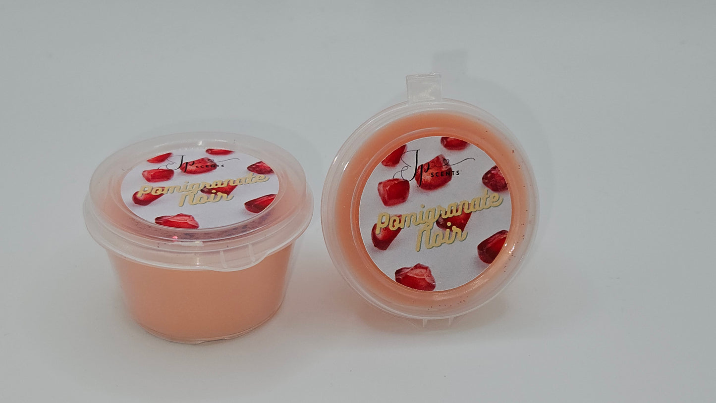 Pomegranate Noir Wax Melt in Packaging – A luxurious home fragrance with a seductive blend of juicy fruits, deep florals, and warm smoky undertones.