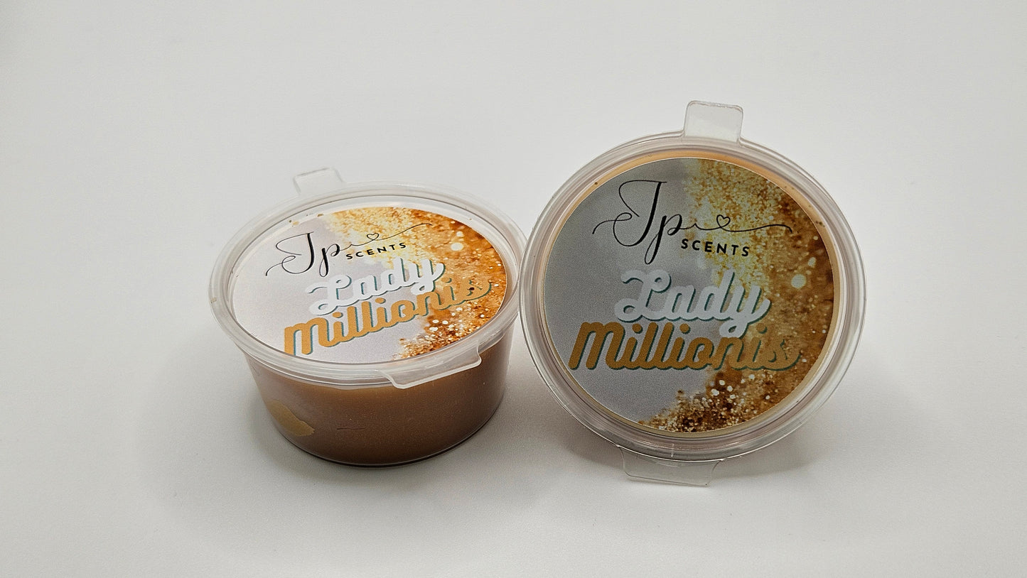 Close-up of Lady Millionis 25g shot pot wax melt: A handcrafted wax melt with a luxurious golden hue, inspired by Paco Rabanne's Lady Million